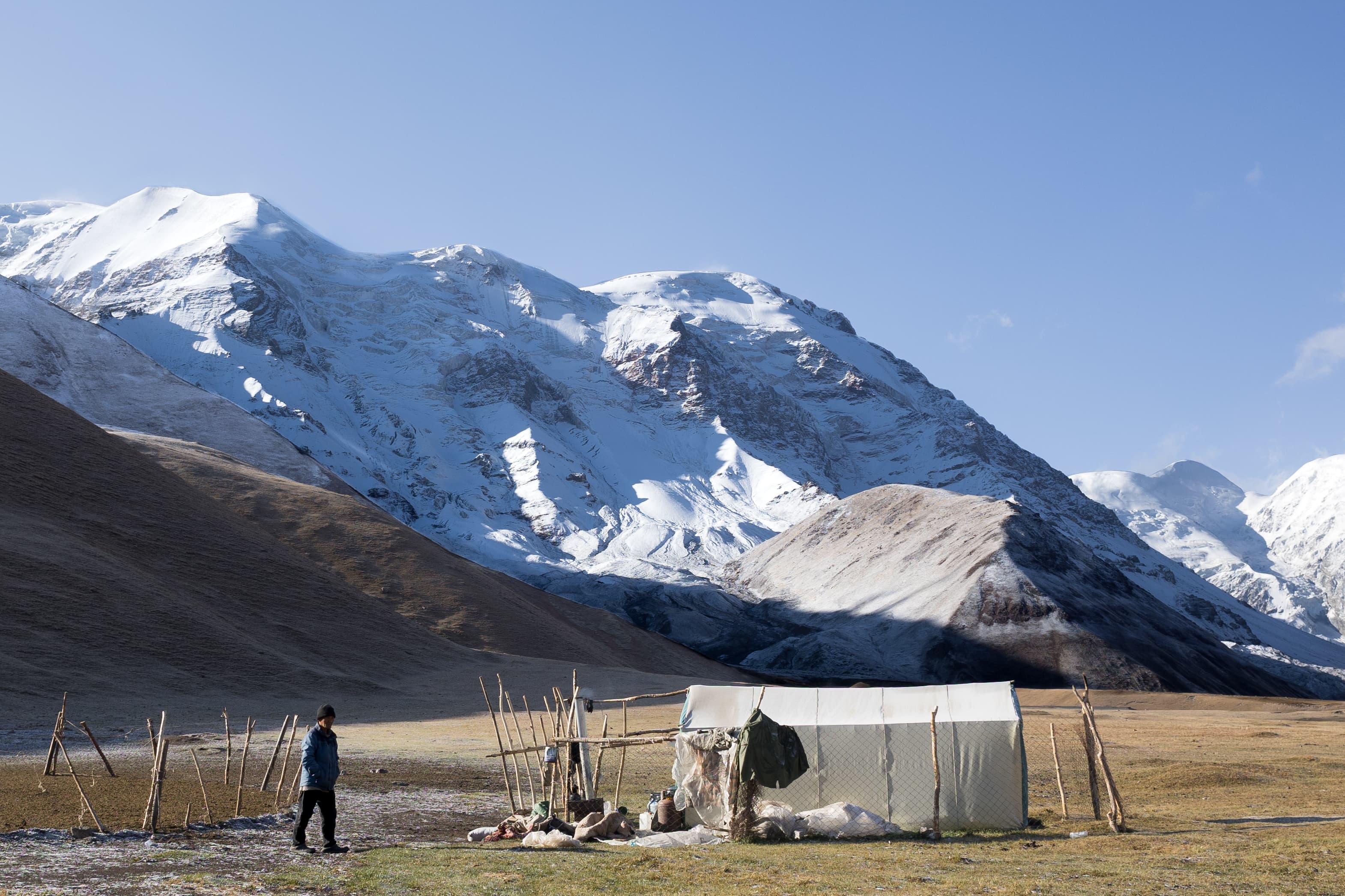 A summer shepherd's tent on the foot of snowy mountains of Tien Shan in Kyrgyzstan